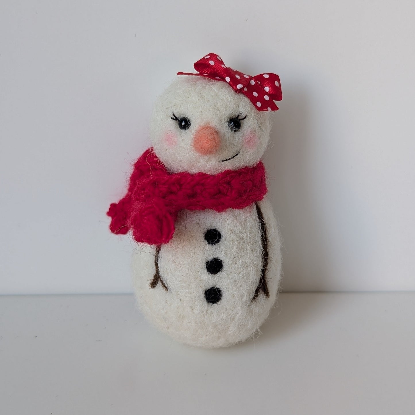 snowman with red scarf and polka dot bow