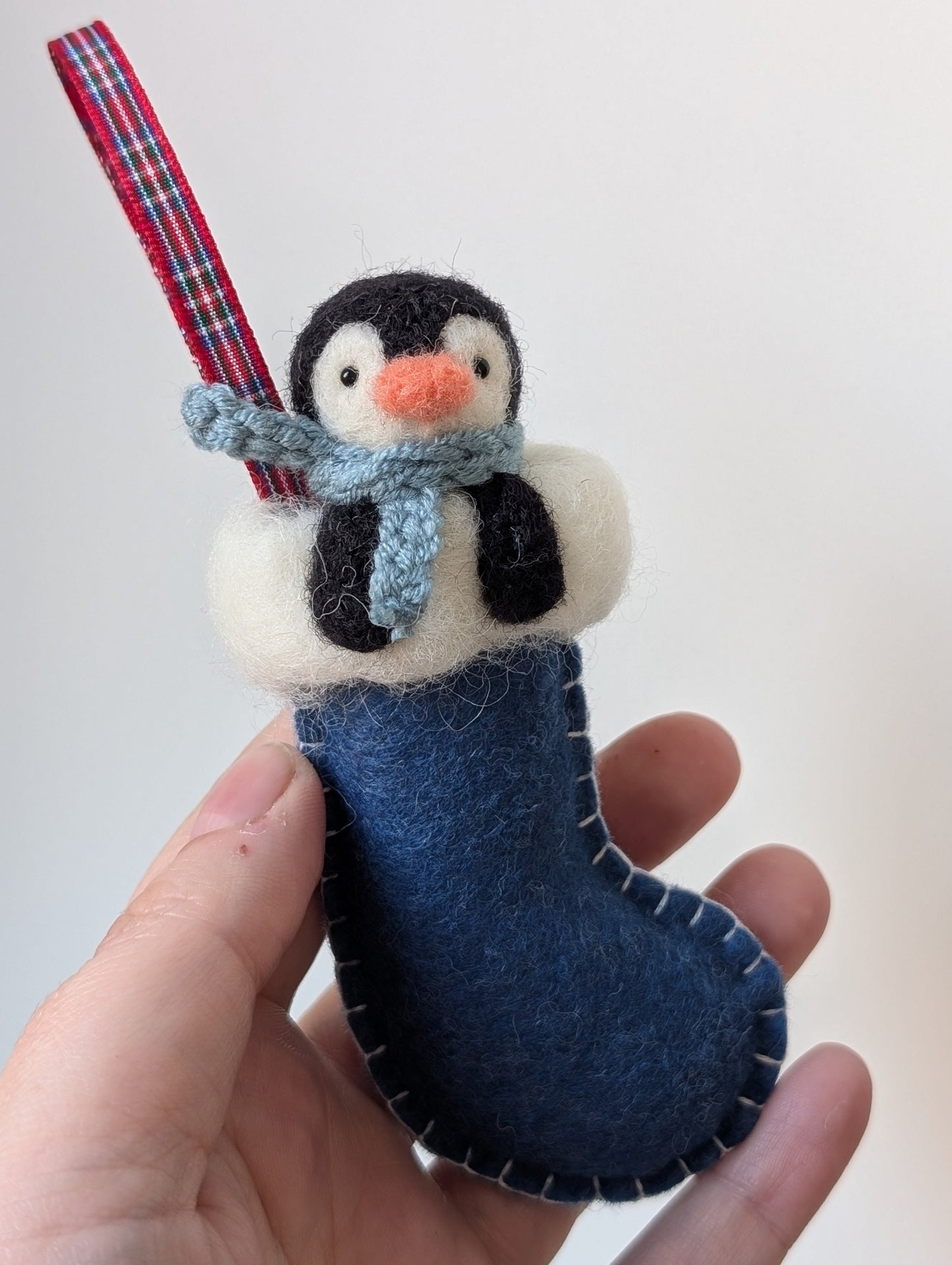 penguin in a blue stocking christmas decoration