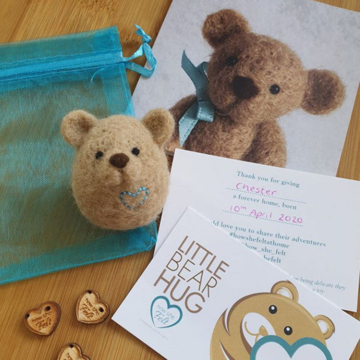 brown little bear hug with a certificate og adoption