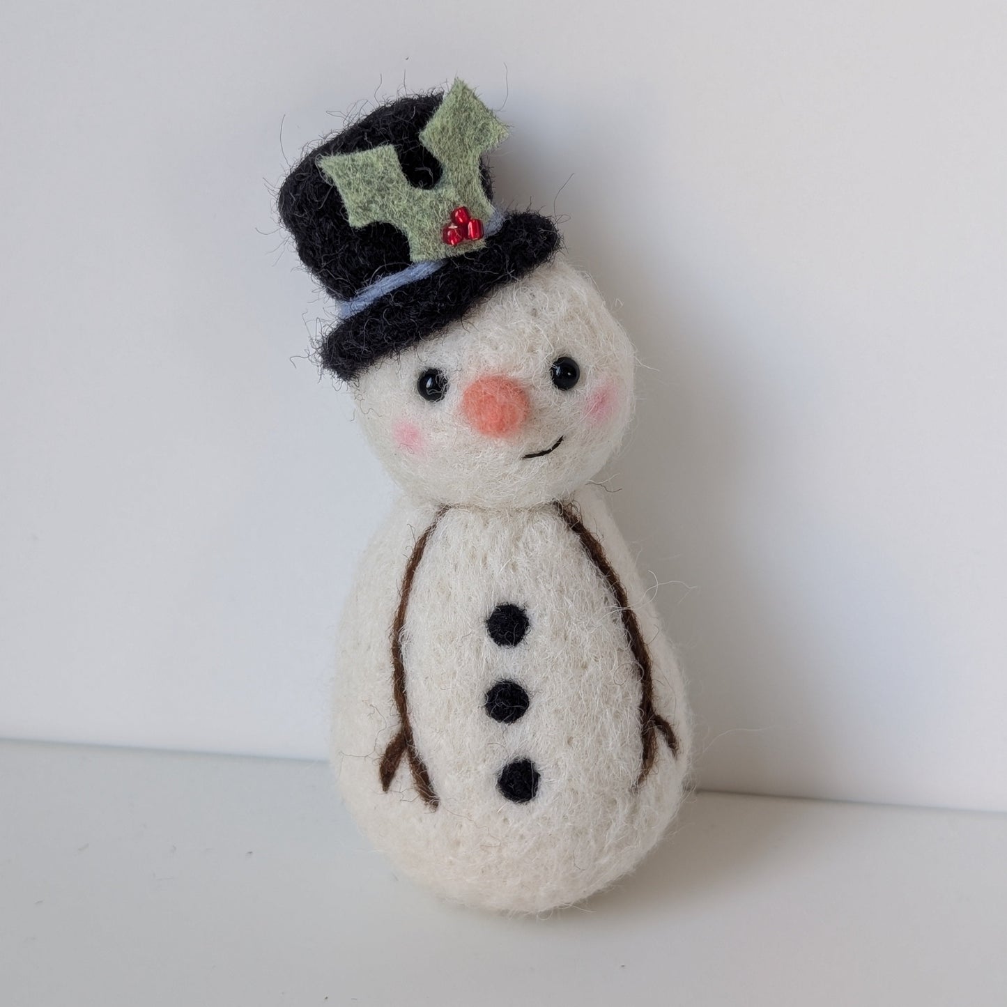 needlefelt snowman with blacktop hat and holly decoration