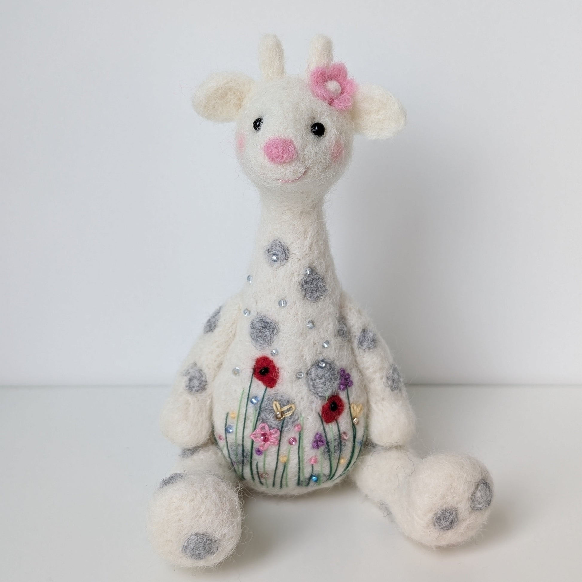 Needlefelted giraffe with floral decoration