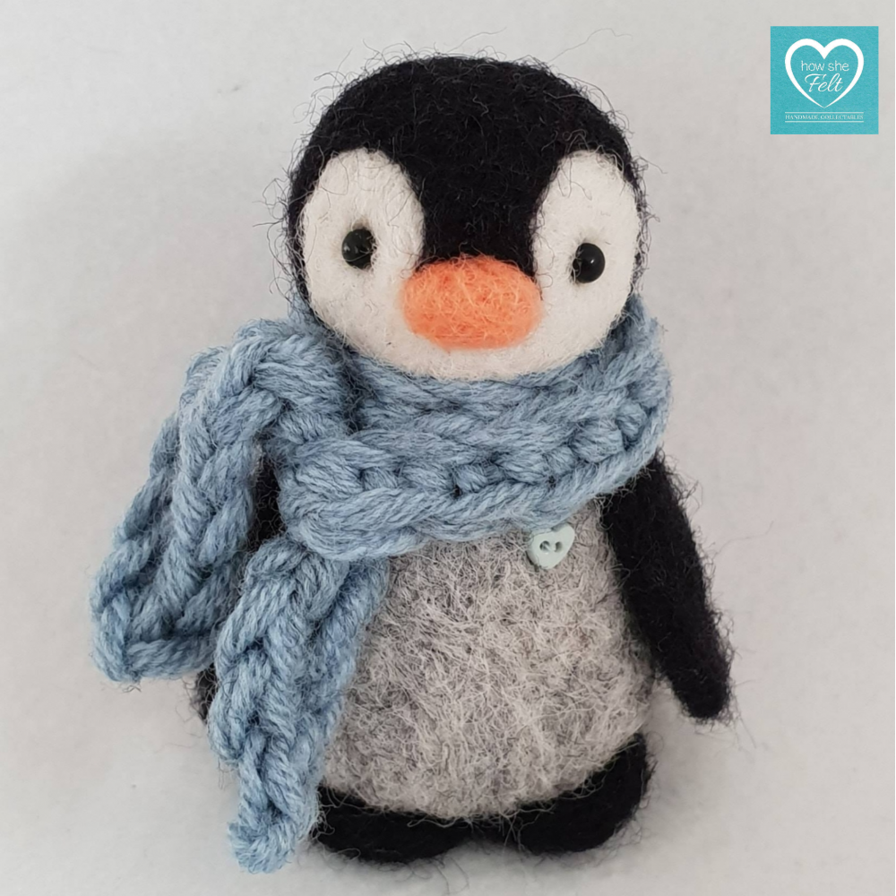 Needlelfelt Penguin wearing a blue crochet scarf