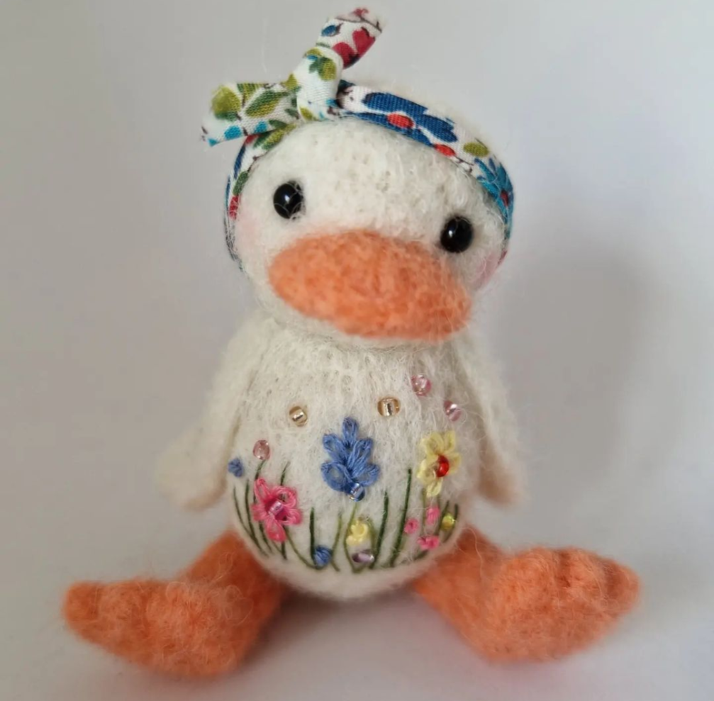 Needlefelt duck with embroidered meadow flowers wearing a floral headscarf 