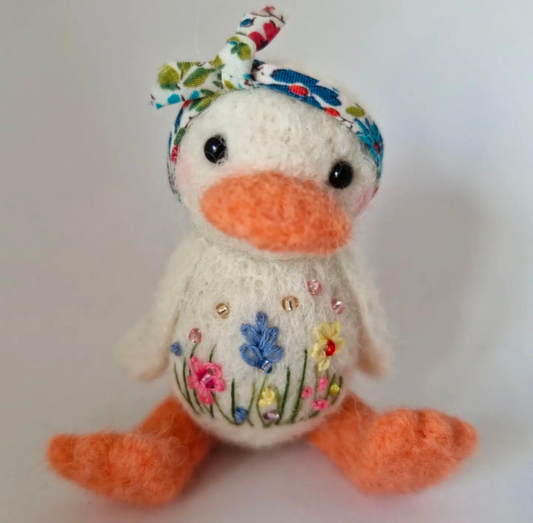 Needlefelt duck with embroidered meadow flowers wearing a floral headscarf 